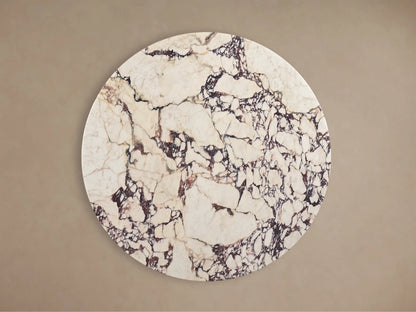 Front view of the Saint Germain Round Stone Dining Table with Launette Base, white stone top with dark veins, brassy gold flared base.