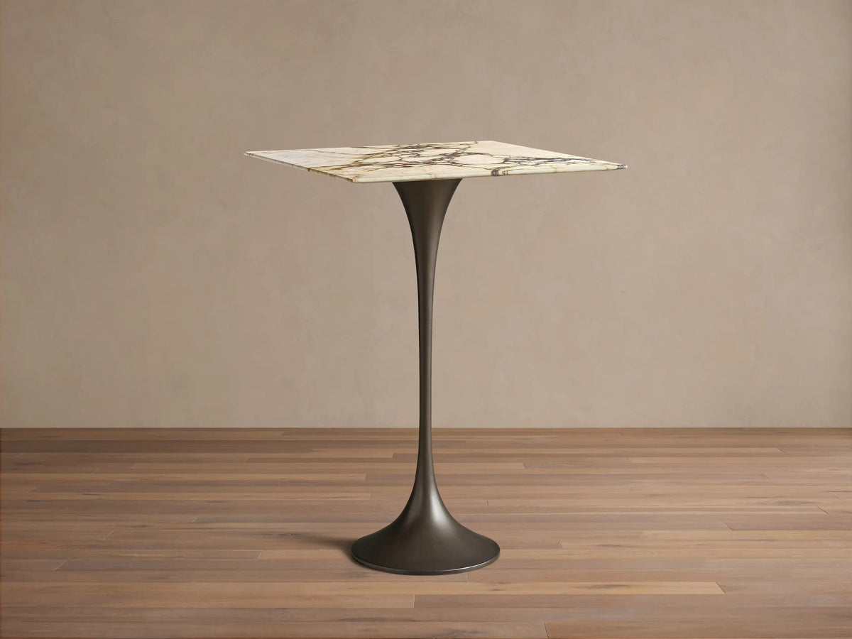 Front view of the Saint Germain Square Bar Table with a square white and gold veined marble top and a dark bronze steel flared base.