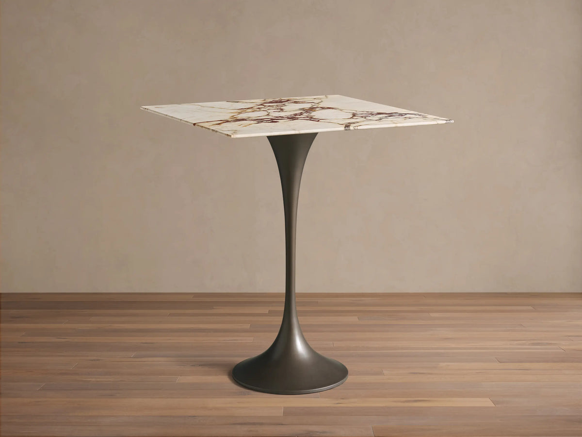 Front view of the Saint Germain Square Counter Table with a white marble top with brown veining and a dark flared steel base.