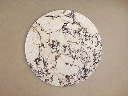 Front view of Saint Germain Round Stone Dining Table with Toulouse Base, white stone top with dark veining, black wood grain base.
