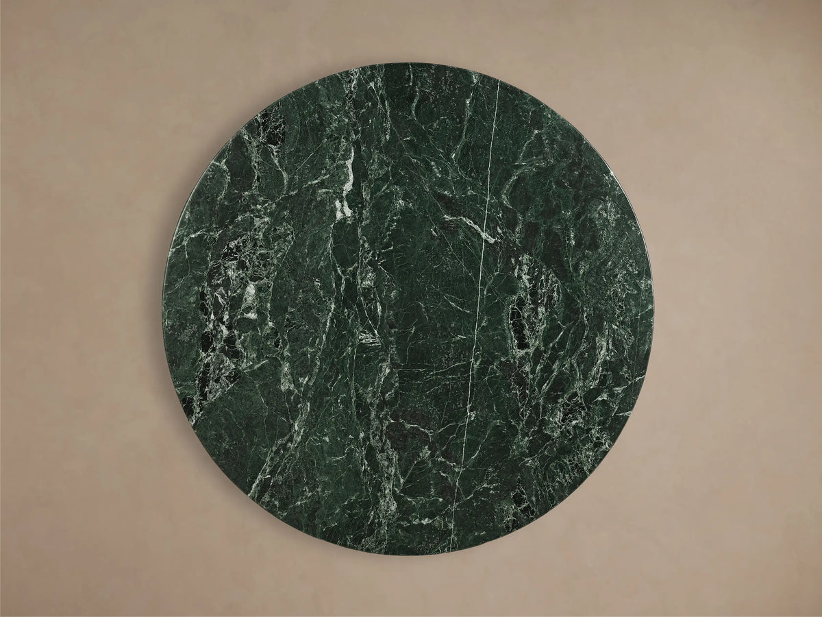 Front view of the dark green marble pattern Saint Germain Round Stone Dining Table with a golden tulip-shaped Launette Base.