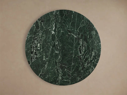 Front view of the dark green stone Saint Germain Round Stone Dining Table with Toulouse Base, with a tapered light oak base.