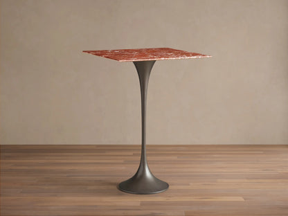Front view of a Saint Germain Square Bar Table featuring a red marble square top and a dark gray tulip-shaped steel base.