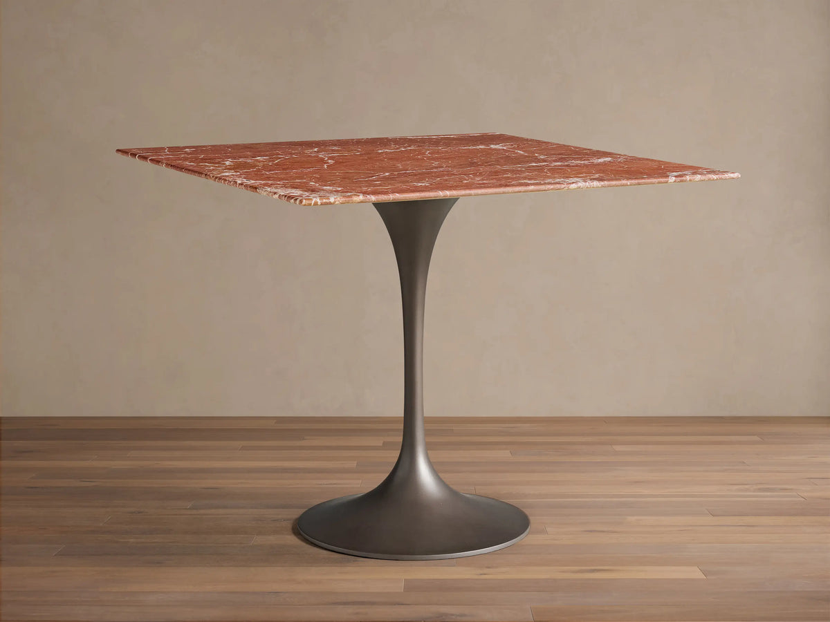Front view of the Saint Germain Square Bistro Table with a red marble top with white veining and dark metal tulip base.
