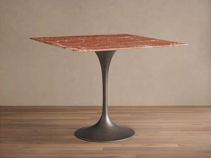 Front view of the Saint Germain Square Bistro Table with a red marble top with white veining and dark metal tulip base.