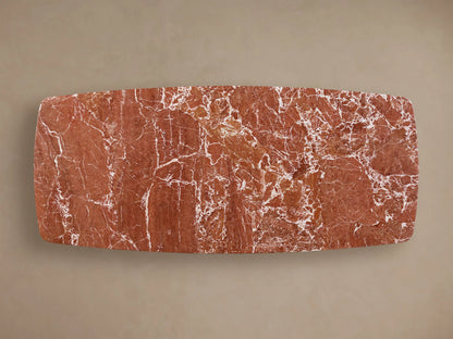 Front view of the reddish-brown veined Saint Germain Stone Dining Table with Toulouse Base, featuring a dark oak base.