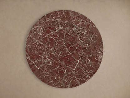 Front view of the Saint Germain Round Stone Dining Table with Dauphine Base, featuring a reddish-brown stone top and split dark oak veneer base.
