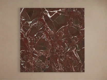 Front view of the Saint Germain Square Bar Table, with a square red marble top and veining, on a flared brass-toned steel base.