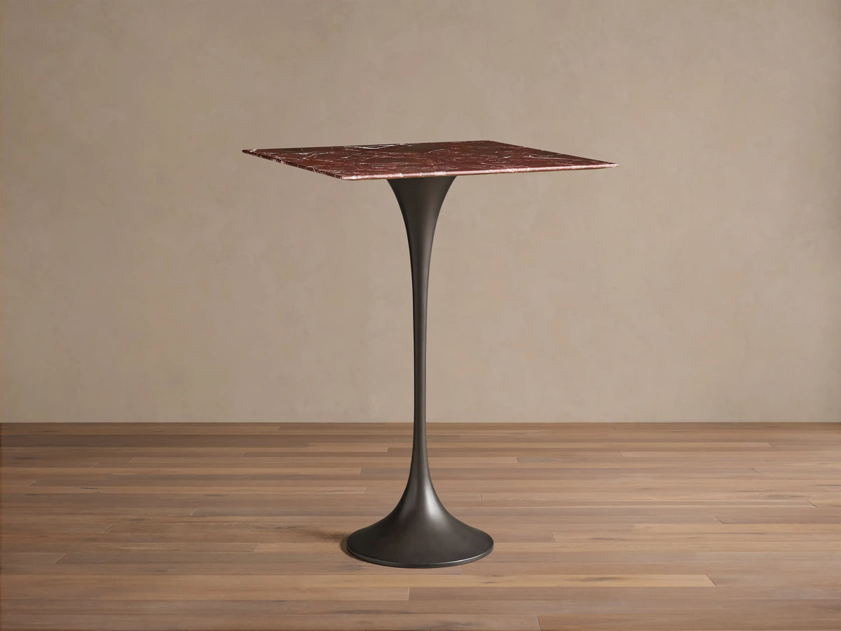 Front view of Saint Germain Square Bar Table with a red marble top and a dark tapered steel pedestal base.
