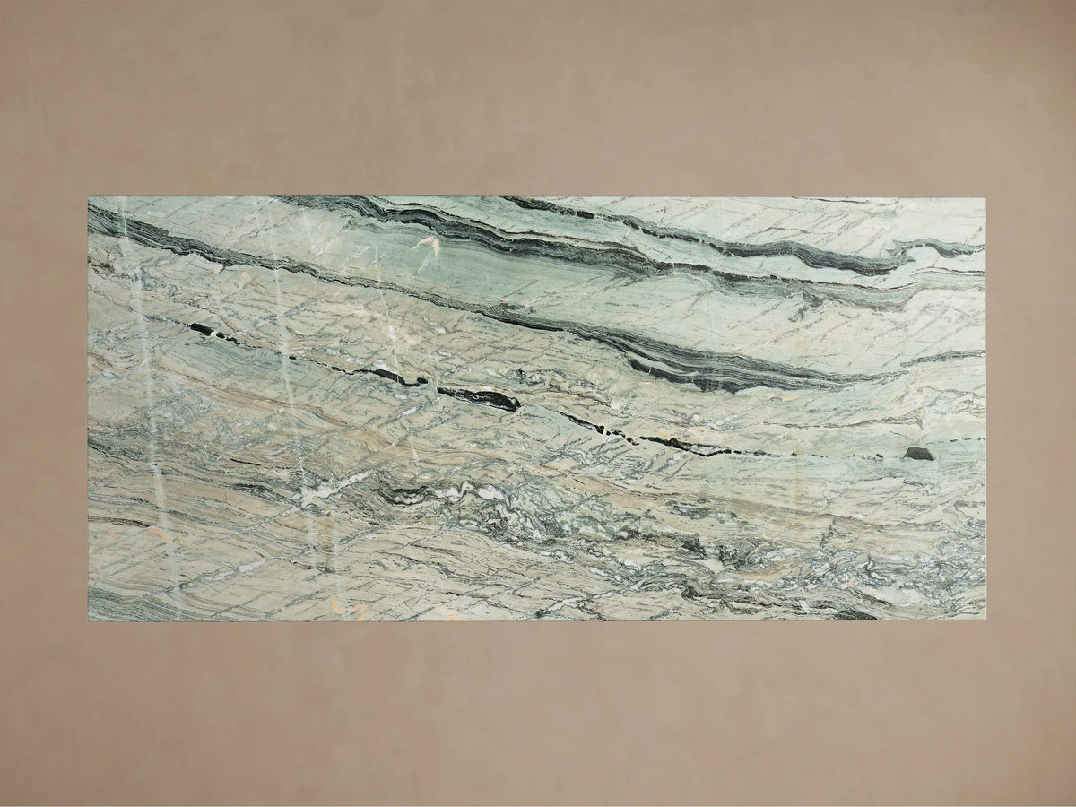Close-up of the Ilaria Dining Table's green, white, black, and beige natural stone top with prominent veining.