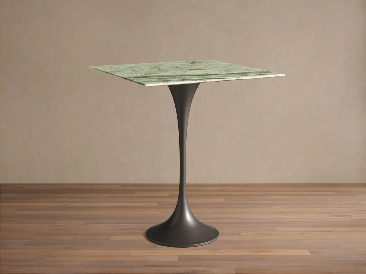 Front view of the Saint Germain Square Counter Table with a green veined marble top and a dark flared steel pedestal base.
