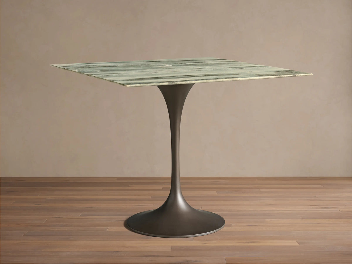Front view of the Saint Germain Square Bistro Table with a green variegated stone square top and dark metal pedestal base.