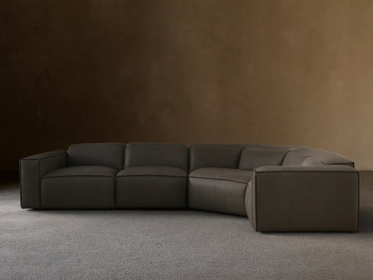 Front view of the dark grey Coburn Motion Leather Four-Piece Corner Wedge Sectional with visible stitching.