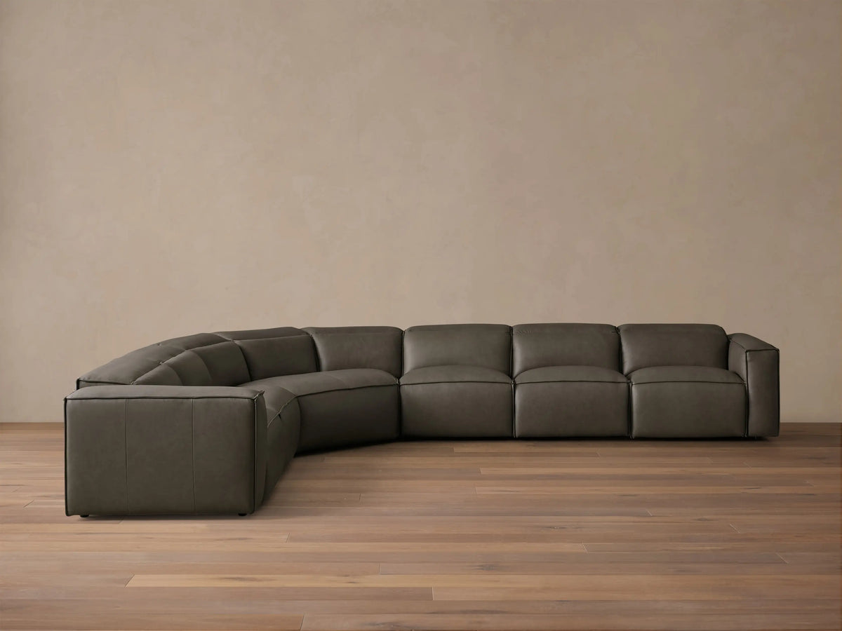 Front view of the dark grey leather Coburn Motion Leather Six-Piece Corner Wedge Sectional with defined stitching.