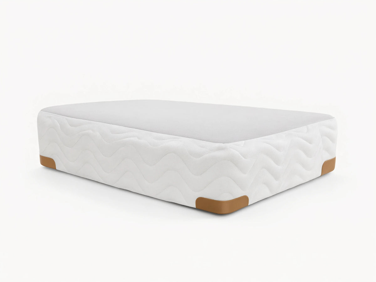 Premium Box Spring with white zigzag patterned fabric, featuring brass-finished metal corner guards on a wooden floor.