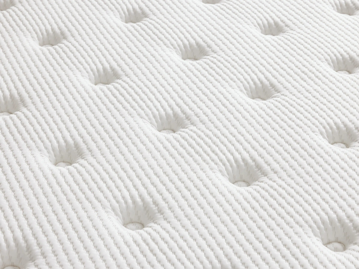 Premium firm mattress on a light wood frame, featuring a quilted white cotton cover with a subtle patterned design against a beige background.