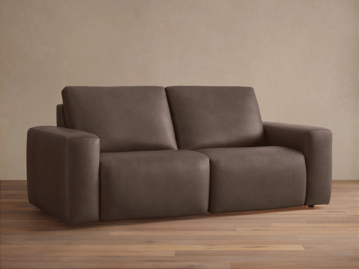 Brennan Leather Two-Piece Motion Sofa, 2 seats, dark brown leather, front view against a light wall on a wood floor.