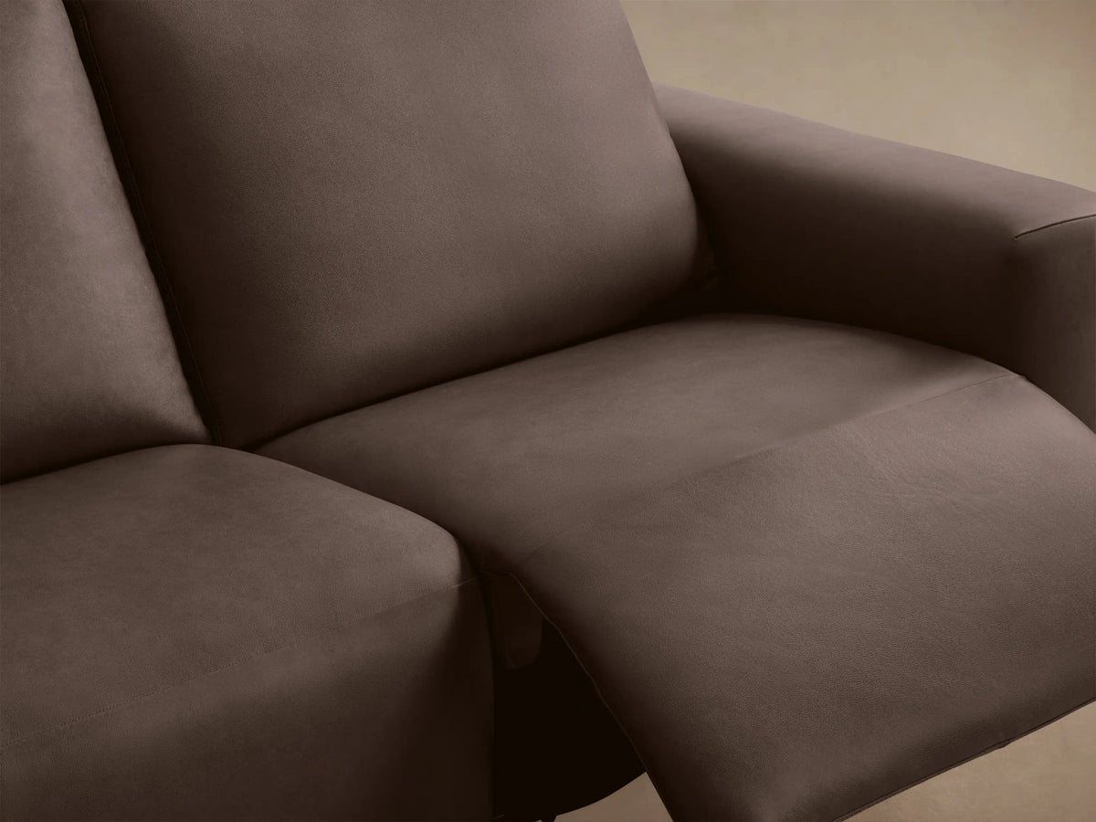Dark brown leather Brennan Two-Piece Motion Sofa, unreclined, shown from front angle on a wooden floor.