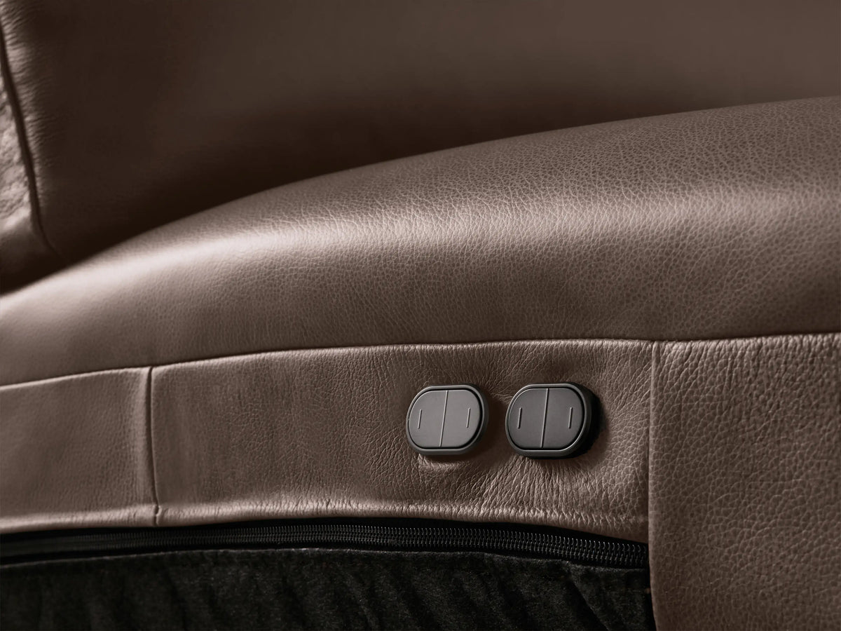 Close-up of a dark brown leather Brennan Motion Sofa, showing a reclined seat with an extended footrest.