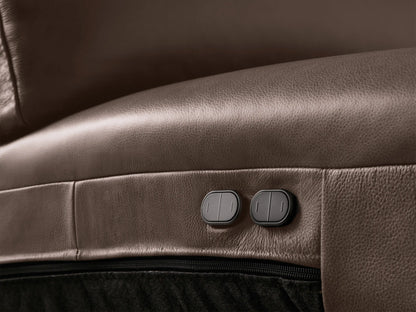 Close-up of a dark brown leather Brennan Motion Sofa, showing a reclined seat with an extended footrest.