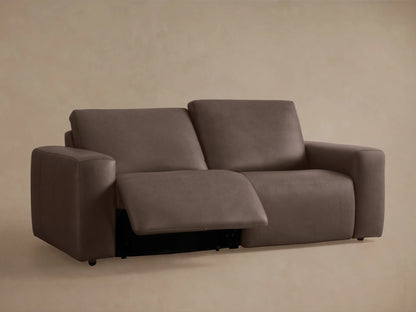 Close-up of Brennan Leather Motion Sofa's brown leather with two embedded control buttons for reclining.