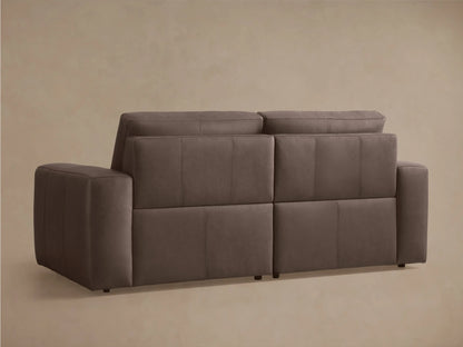 Brennan Leather Two-Piece Motion Sofa, dark taupe, viewed from the front-right with one extended reclined footrest, on a neutral background.
