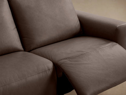 Dark brown leather Brennan Three-Piece Motion Sofa, full view, with three distinct cushioned seats, against a light brown wall.
