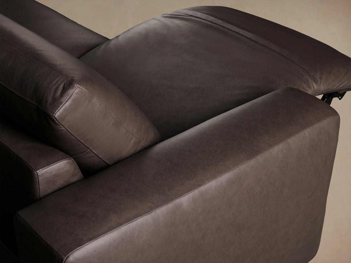 Brennan Four-Piece Motion Sectional in dark brown leather, with modular design, full front view on a wood floor.