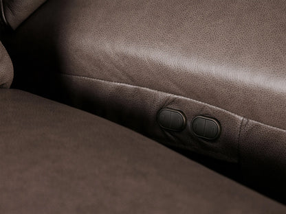 Close-up of a Brennan Leather Four-Piece Motion Sectional, highlighting rich dark brown leather texture and stitching on cushions.