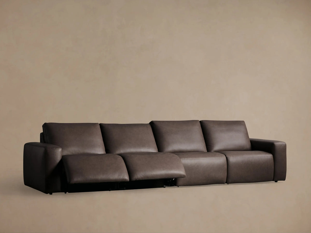 Close-up of the Brennan Leather Sectional's textured brown leather upholstery with two black oval power recline control buttons.