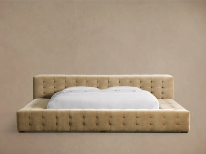 Regent Bed, light tan tufted upholstered headboard & frame, featuring a white mattress with clean white bedding.
