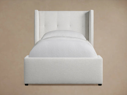 Wyller Box-Tufted Twin Bed with a light gray upholstered headboard, box tufting, and matching gray upholstered frame, on a wood floor.