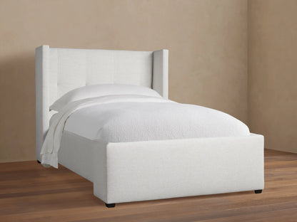Light gray upholstered Wyller Box-Tufted Twin Bed with wingback, box-tufted headboard & white bedding on wood floor.