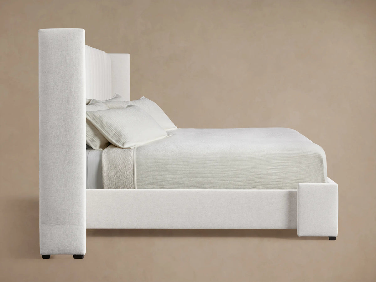 Close-up of Wyller Channel-Stitched Extended Headboard, showing off-white textured fabric with plush vertical channels.