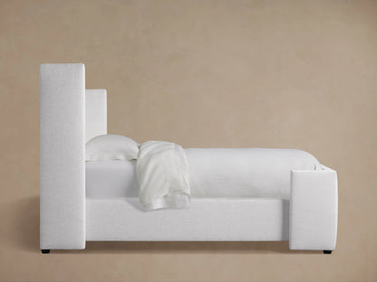Close-up, angled view of Wyller Box-Tufted Twin Bed headboard. Light gray textured fabric, plush box tufting & buttons.