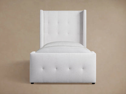 Upholstered light gray Wyller Box-Tufted Twin Bed with tall, plush headboard & footboard, white bedding, wood floor.