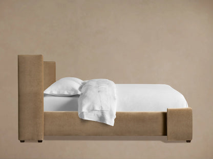 Close-up of Wyller Channel-Stitched Bed headboard. Plush tan velvet fabric with vertical channel stitching details.