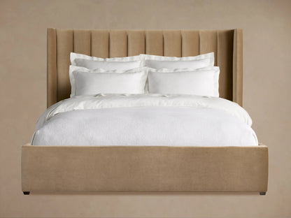 Wyller Channel-Stitched Bed with Low Footboard, upholstered in warm beige with a tall channel-stitched headboard, white bedding.