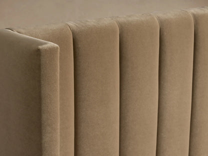 Wyller Channel-Stitched Bed with low footboard. Upholstered in beige fabric, featuring a tall, winged headboard with vertical channel stitching. Dressed with white duvet and pillows.