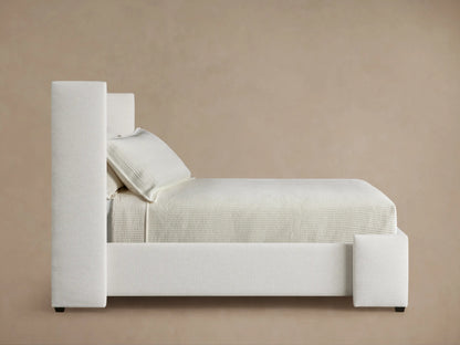Close-up of Wyller Channel-Stitched Twin Bed headboard, showing plush vertical channels in light beige textured upholstery.