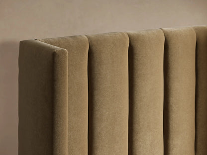 Wyller Channel-Stitched Twin Bed, upholstered in plush beige fabric with a vertically channel-stitched headboard and white bedding.