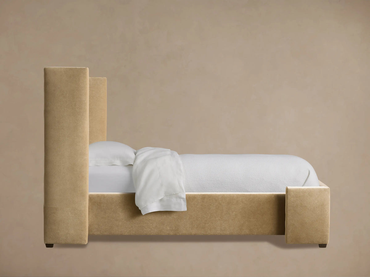 Close-up of Wyller Twin Bed headboard. Plush light brown fabric with prominent vertical channel-stitched detailing.