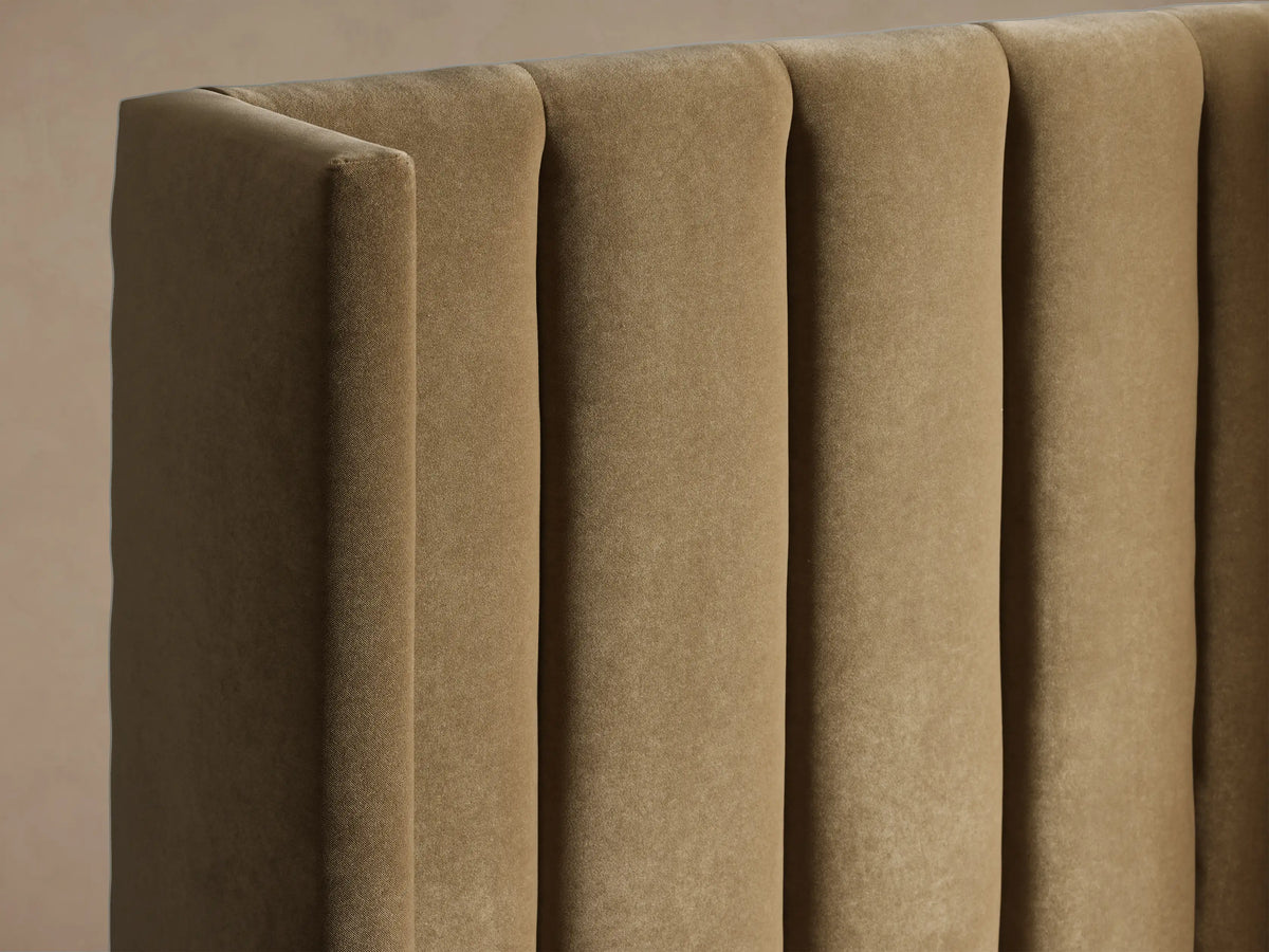 Wyller Channel-Stitched Twin Bed, front view. Tan upholstered bed with tall, vertically channel-stitched headboard, white bedding.
