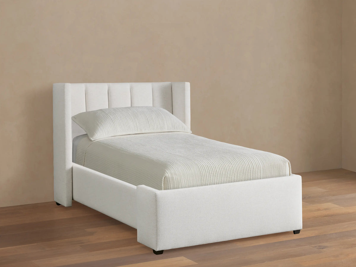 Wyller Channel-Stitched Twin Bed, light beige upholstered bed with vertical channel stitching on headboard, on wood floor.