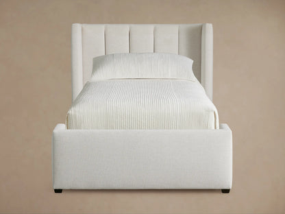 Wyller Channel-Stitched Twin Bed, light beige upholstered bed with vertical channel stitching on headboard, on wood floor.