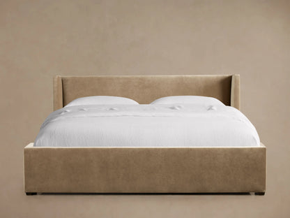 Front view of a tan Wyller Bed with Low Headboard, featuring a low, flared headboard and white bedding.
