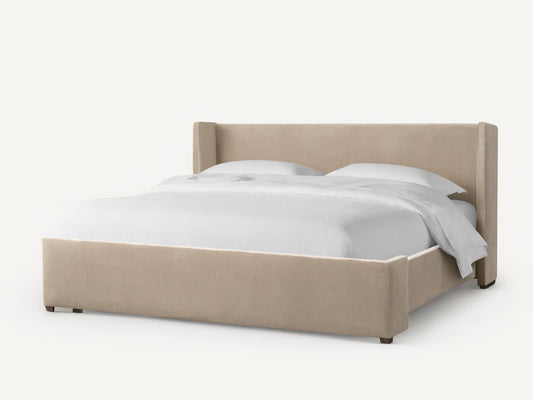 Front view of an upholstered beige Wyller Bed with Low Headboard, featuring white bedding.