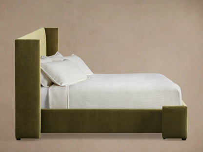 Close-up of the olive green upholstered headboard of the Wyller Bed, showing its clean lines and padded corner detail.