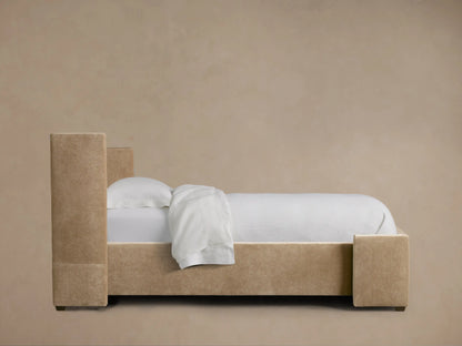 Wyller Twin Bed: Close-up of warm beige upholstered headboard corner, showing plush fabric and neat stitching.
