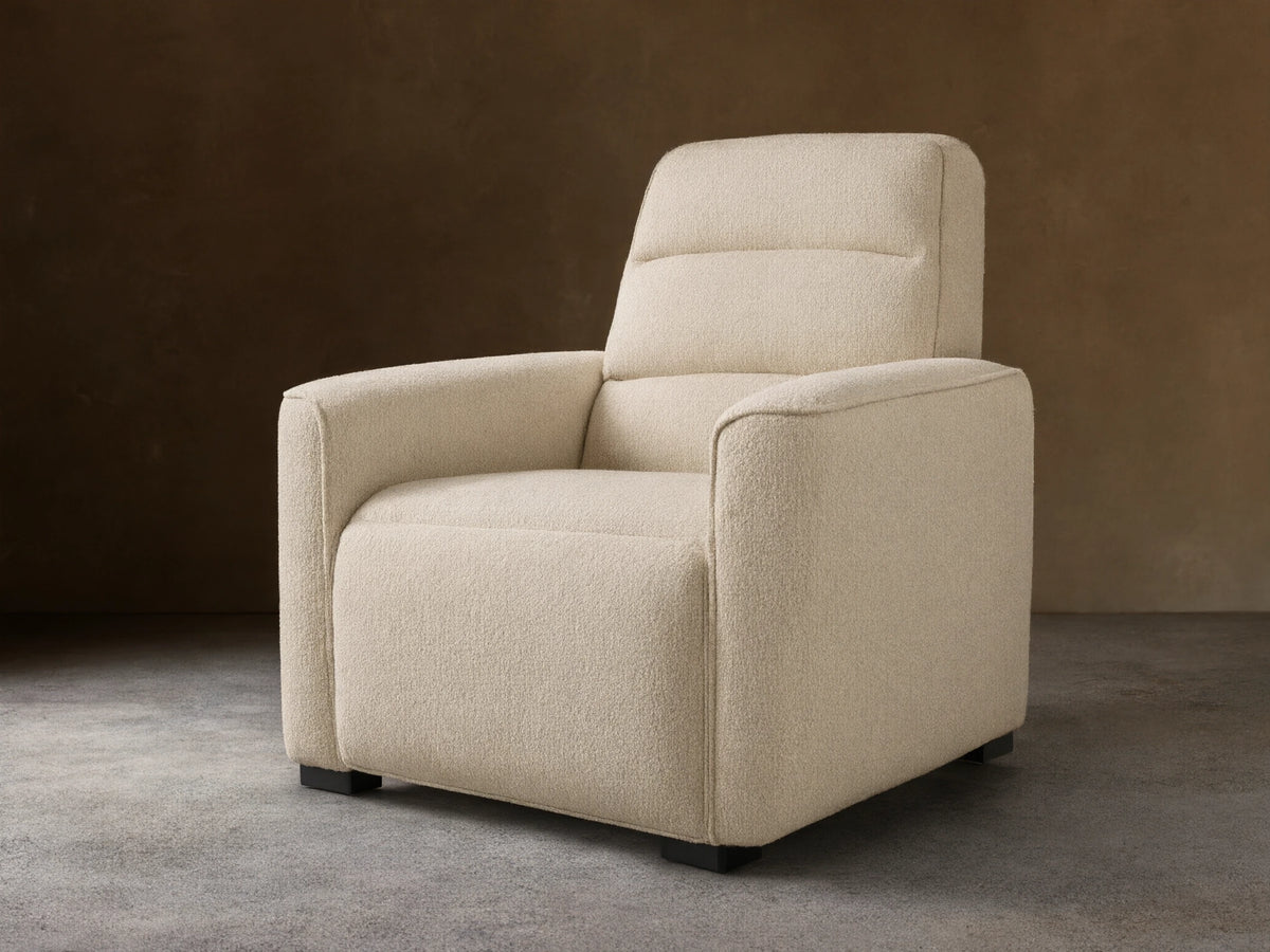Front view of a Cream Borough Motion Recliner with textured bouclv© fabric, plush arms, and a quilted backrest.
